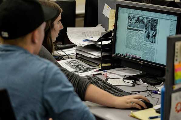 Two students working together on the paper.